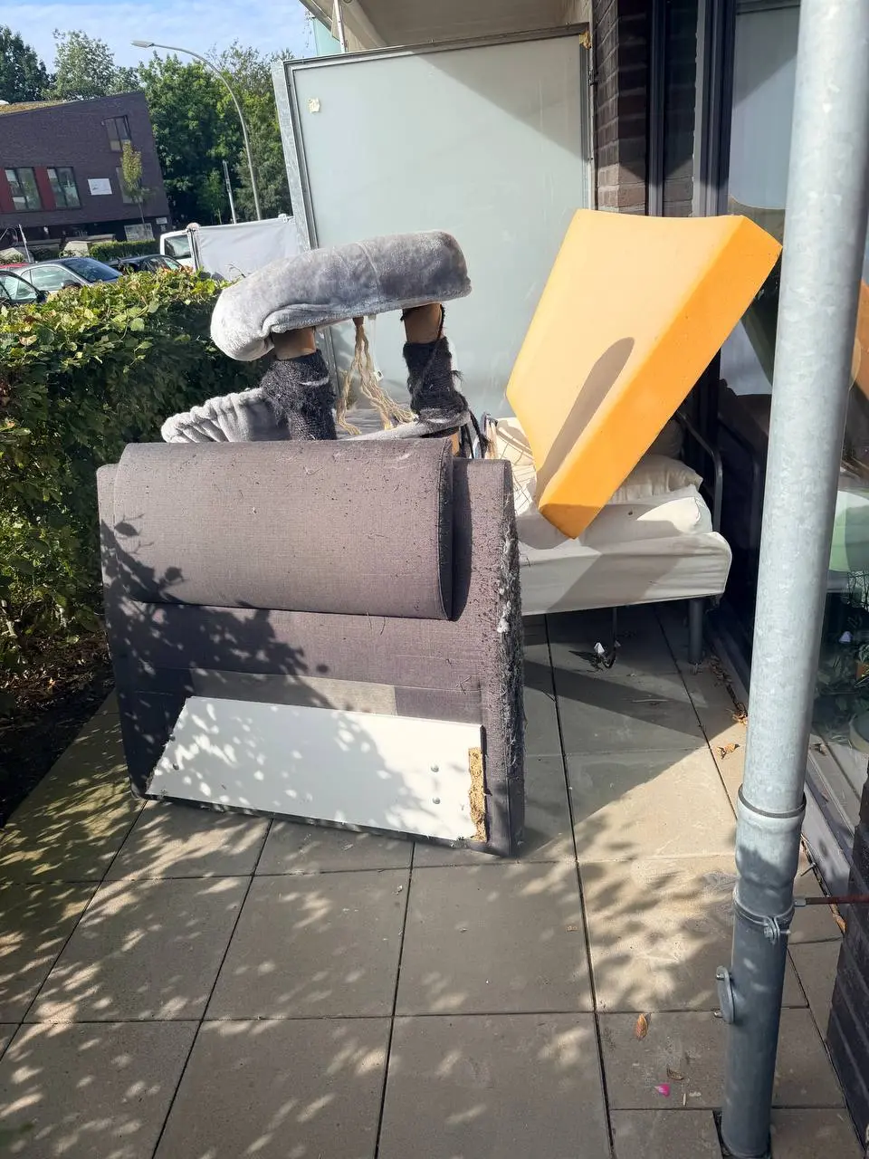 Zerlegtes Polsterbett mit Matratze auf einer Terrasse in Hamburg-Eppendorf vor der Abholung